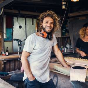 Two happy young men working on in their workshop