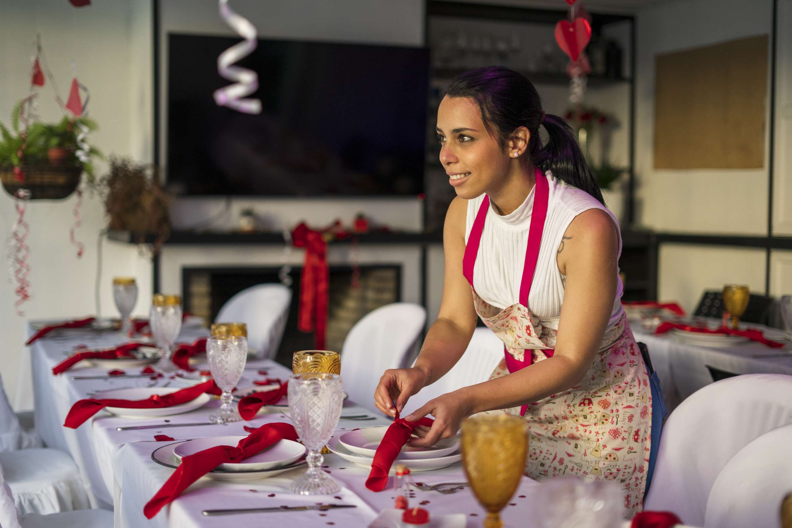 A woman is decorating the tables of a party