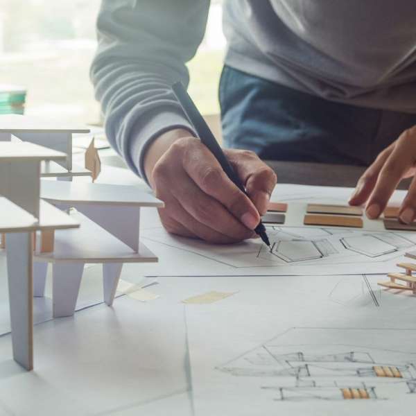 An architect working with his design on a paper