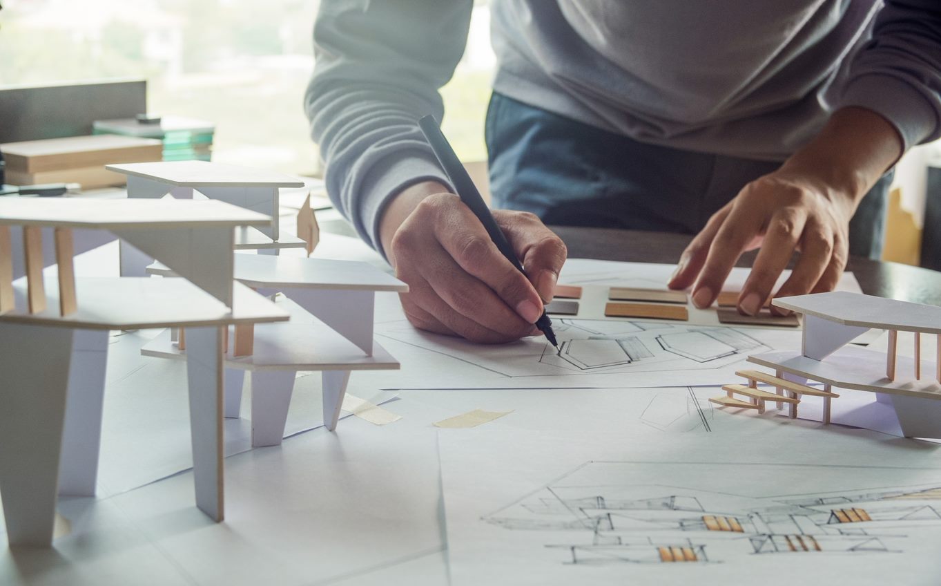 An architect working with his design on a paper