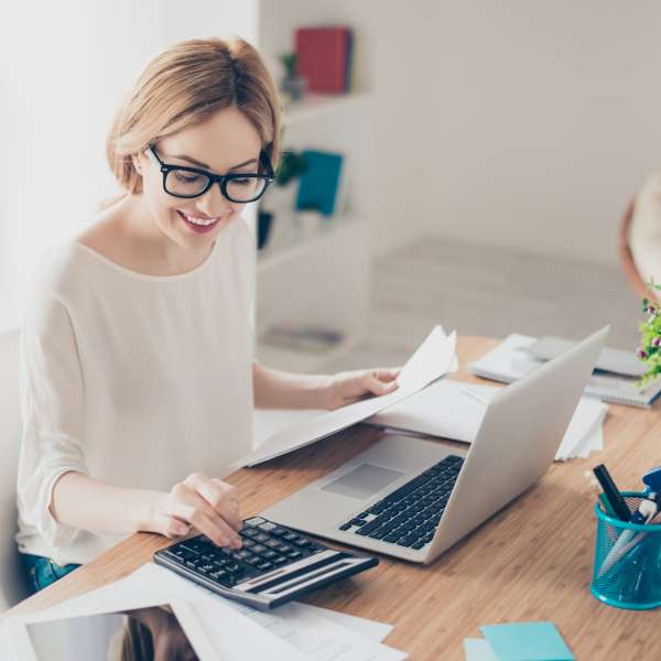 Happy consultant working with computer and calculator