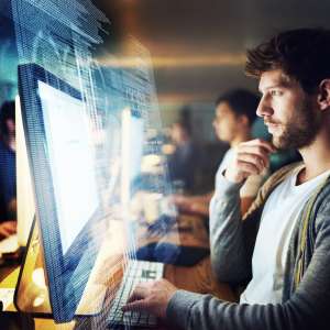 A programmer working on a computer code at night