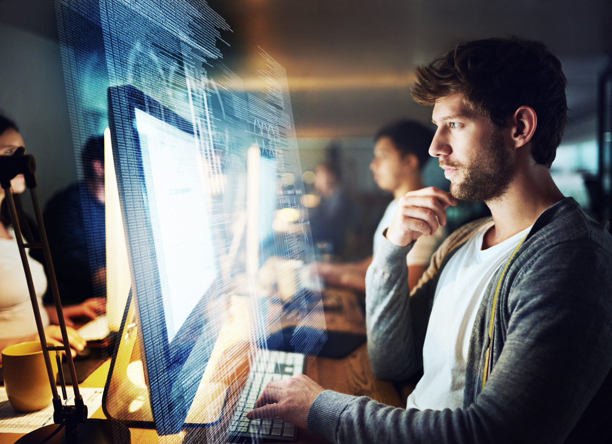 A programmer working on a computer code at night