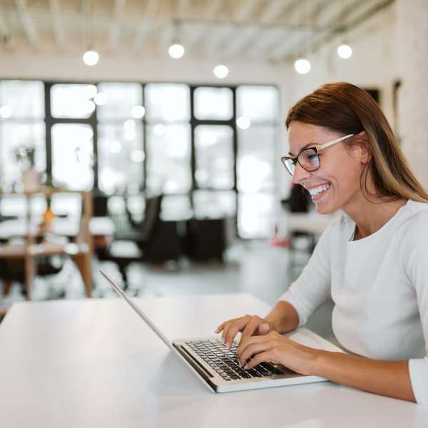 A young business woman using laptop in office.