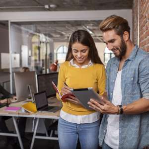 Errors and Omissions insurance Michigan - Young man and woman using the tablet and working together