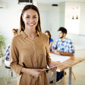 Businesswoman holding tablet at conference tablet having company meeting