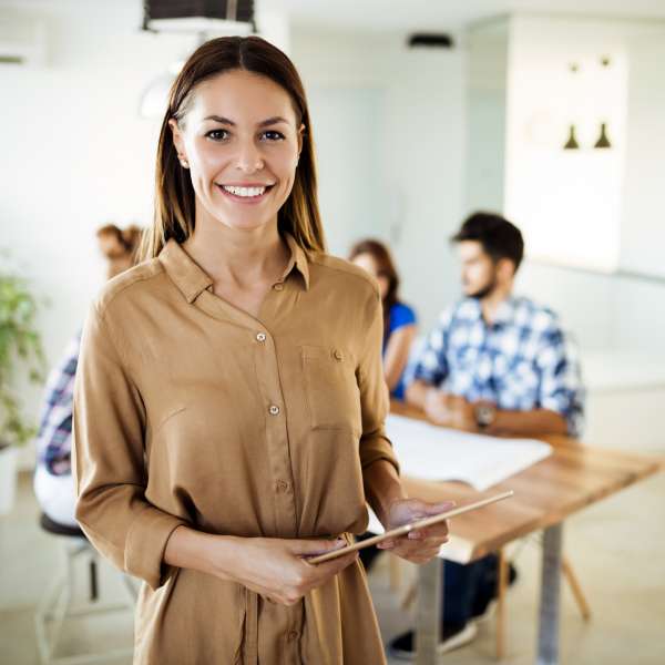 Businesswoman holding tablet at conference tablet having company meeting