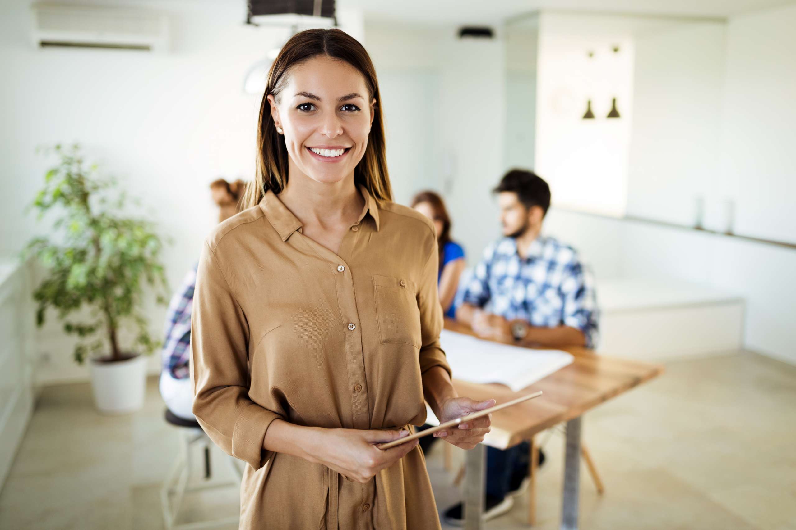Businesswoman holding tablet at conference tablet having company meeting