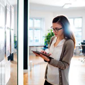 Woman reviewing proofs in front of office