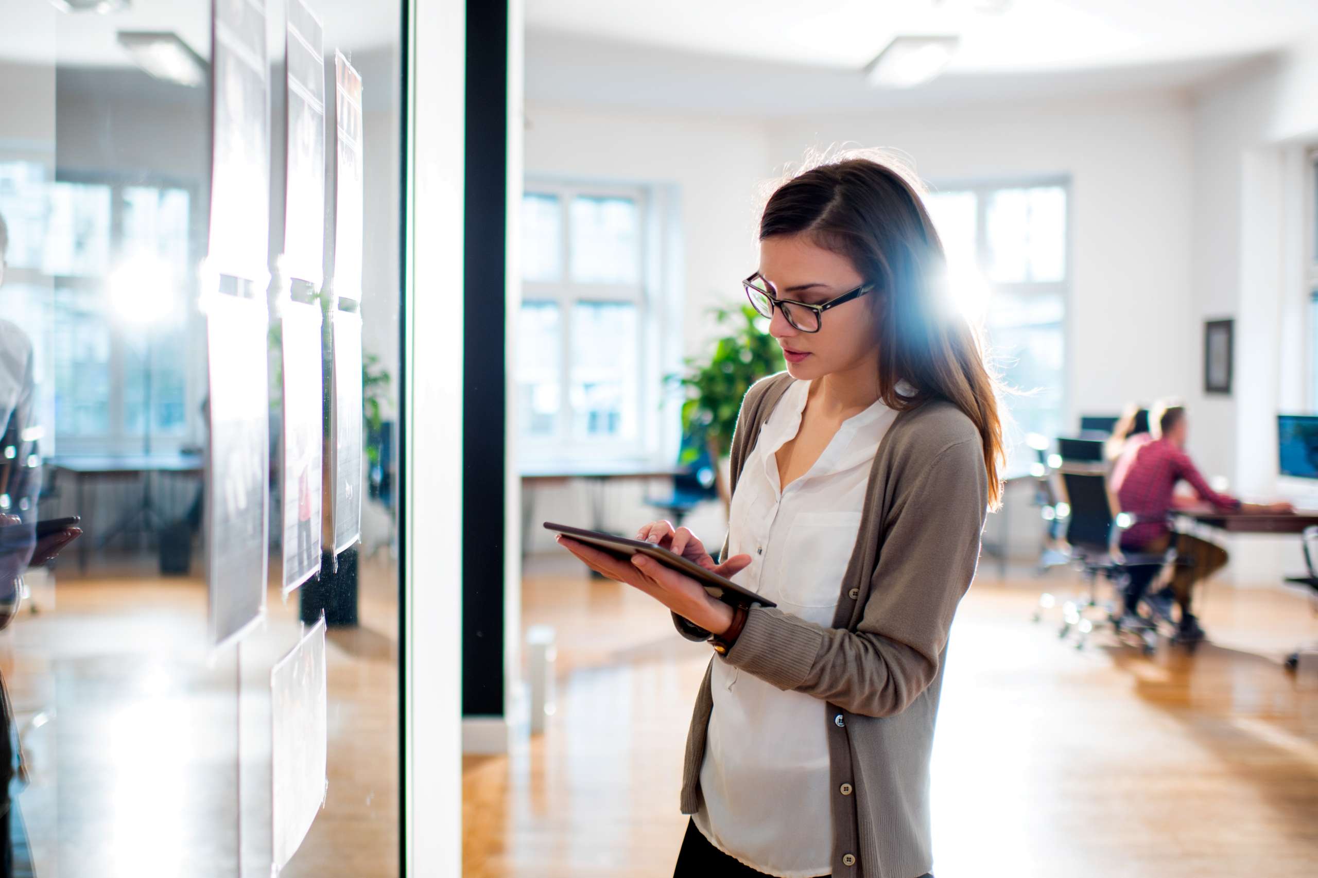 Woman reviewing proofs in front of office