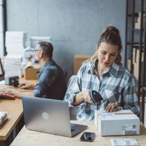 Two business partners working together at warehouse for online seller business.