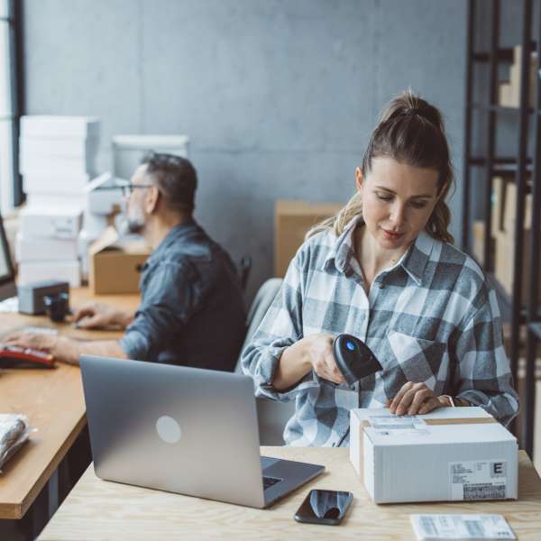Two business partners working together at warehouse for online seller business.