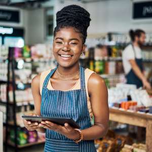 A woman using a digital tablet while working in a store