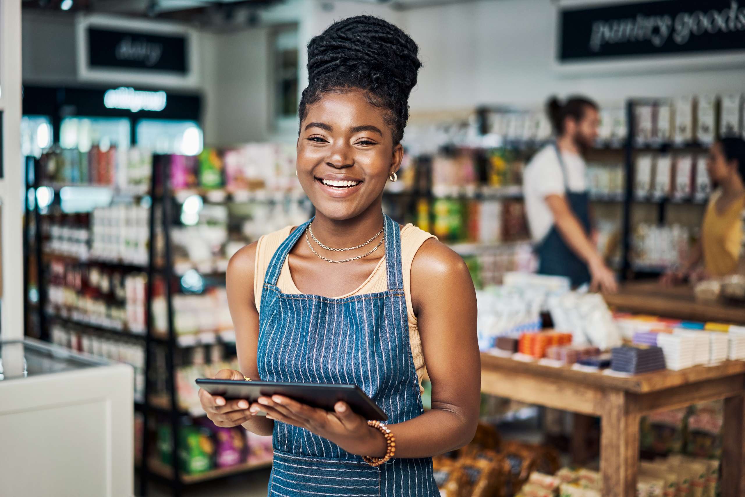 A woman using a digital tablet while working in a store