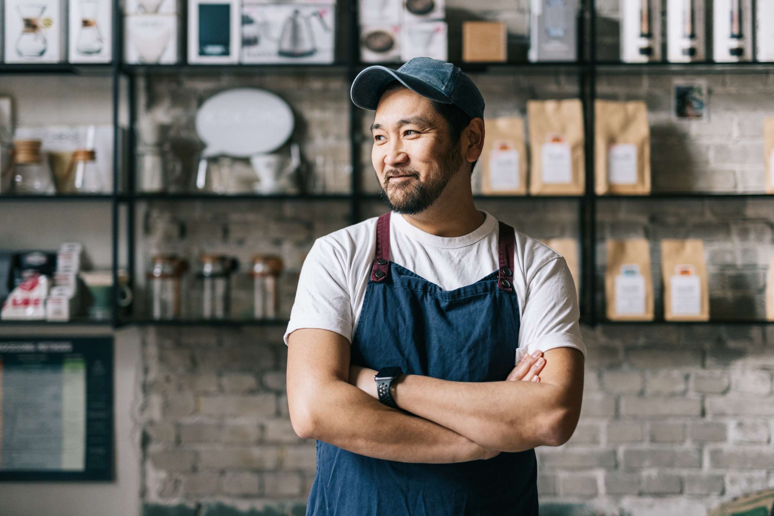 Confident cafe owner standing at his coffee shop