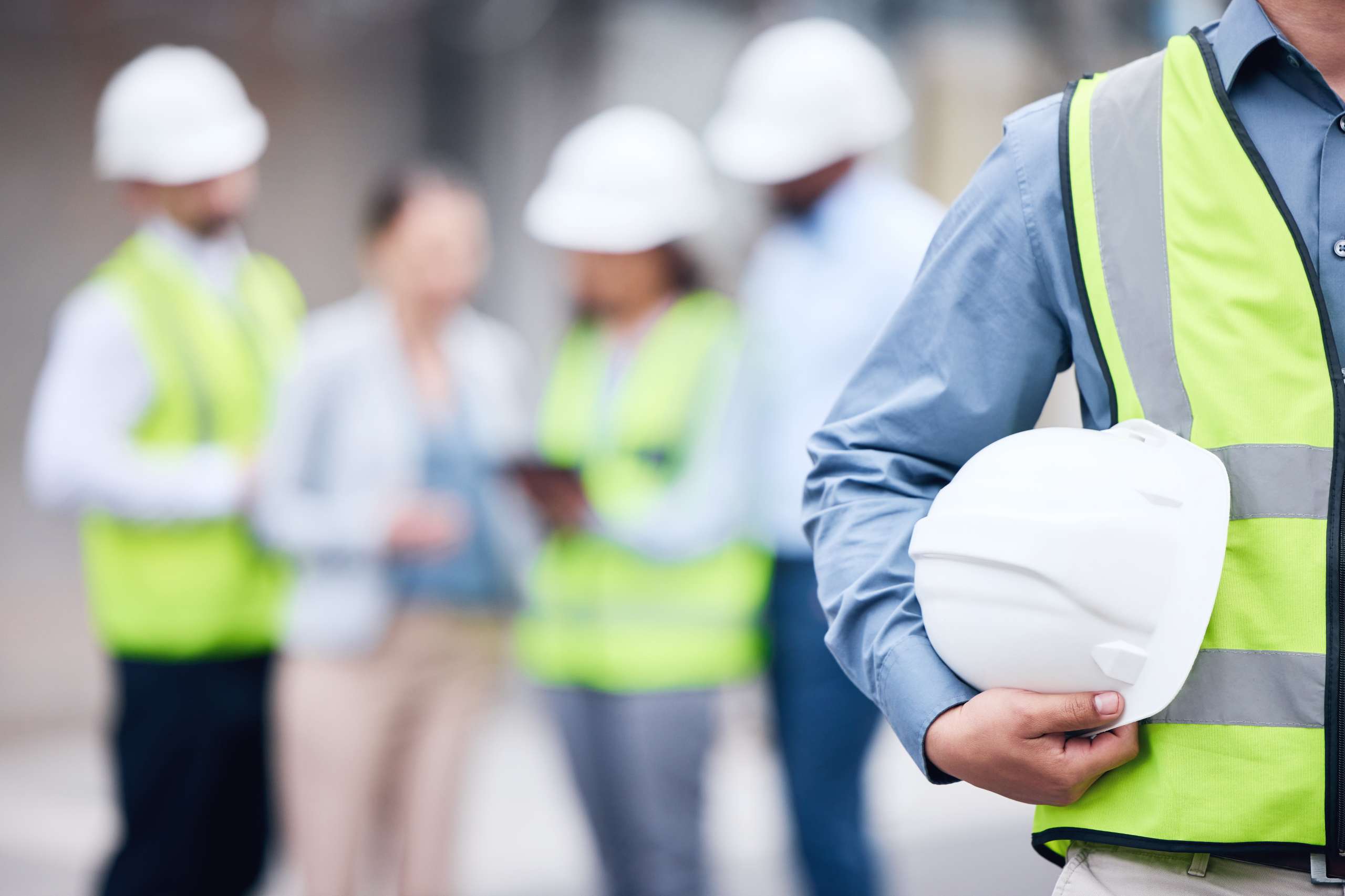 Architect holding a helmet at a building site