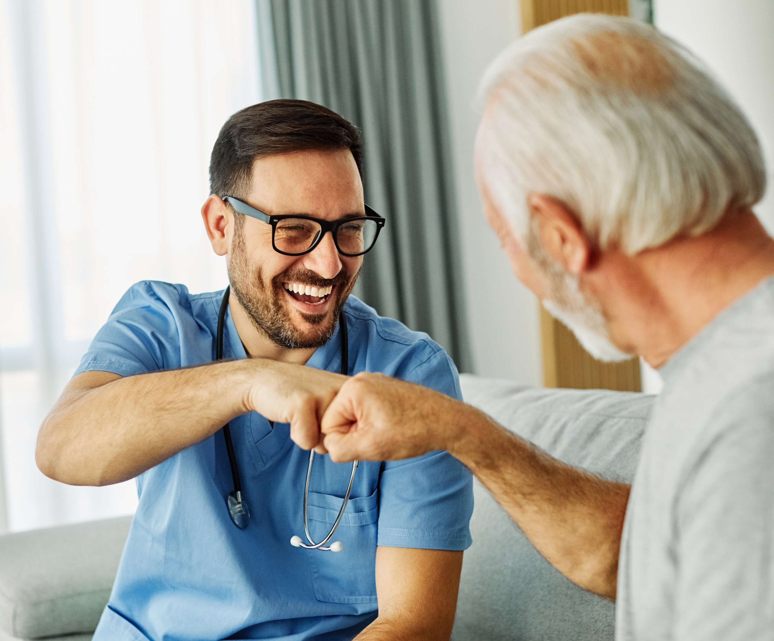 Caregiver with senior man at home.