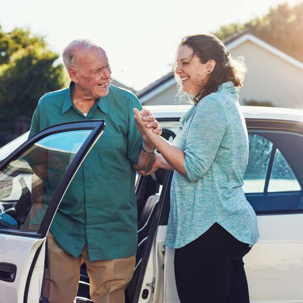 Caregiver woman with old man for assisted living.