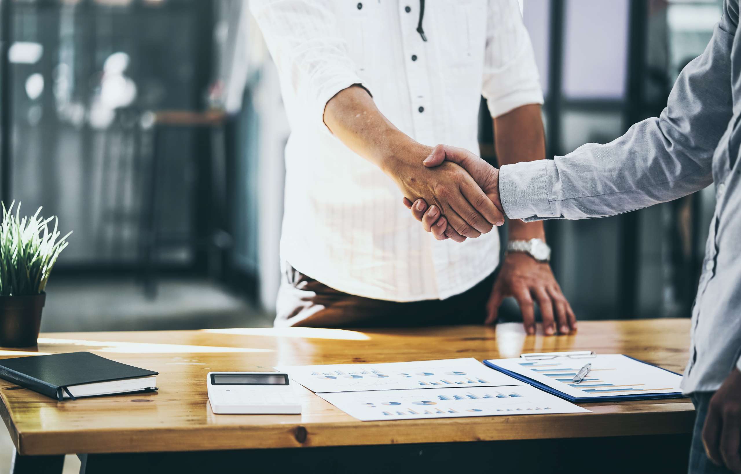 Business shaking hands between two colleagues,