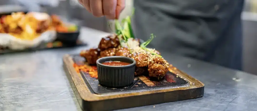 A header image for a blog about the highest-rated restaurants that sell chicken wings in each of the top 100 U.S. cities.