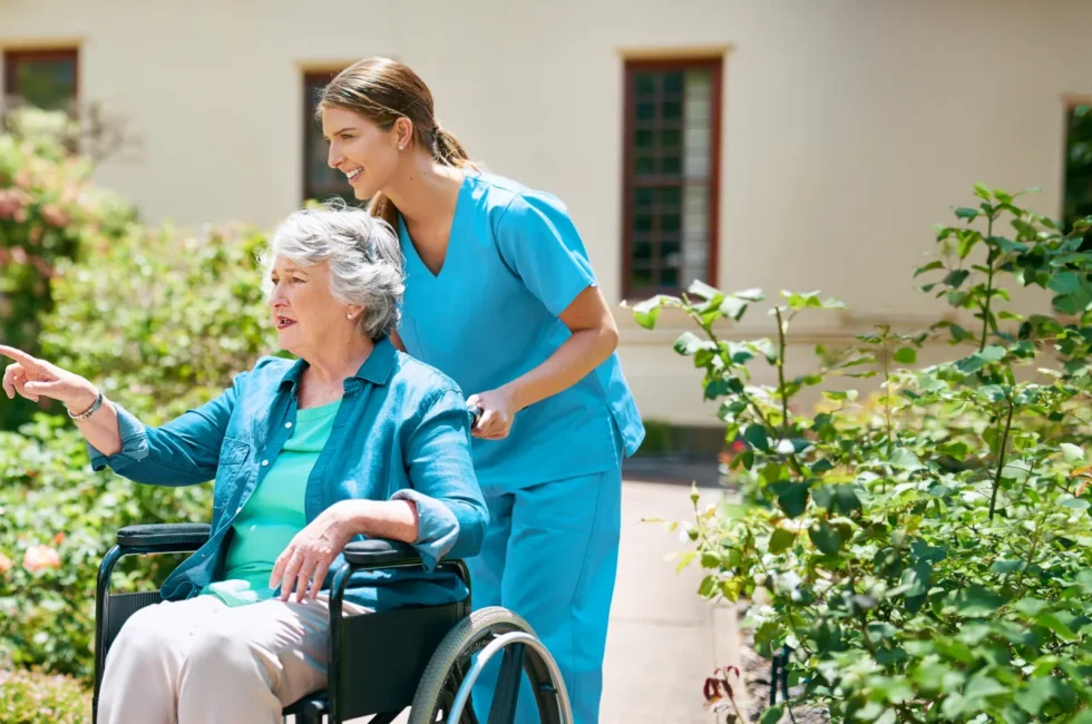 Home Health aide pushing lady in wheelchair