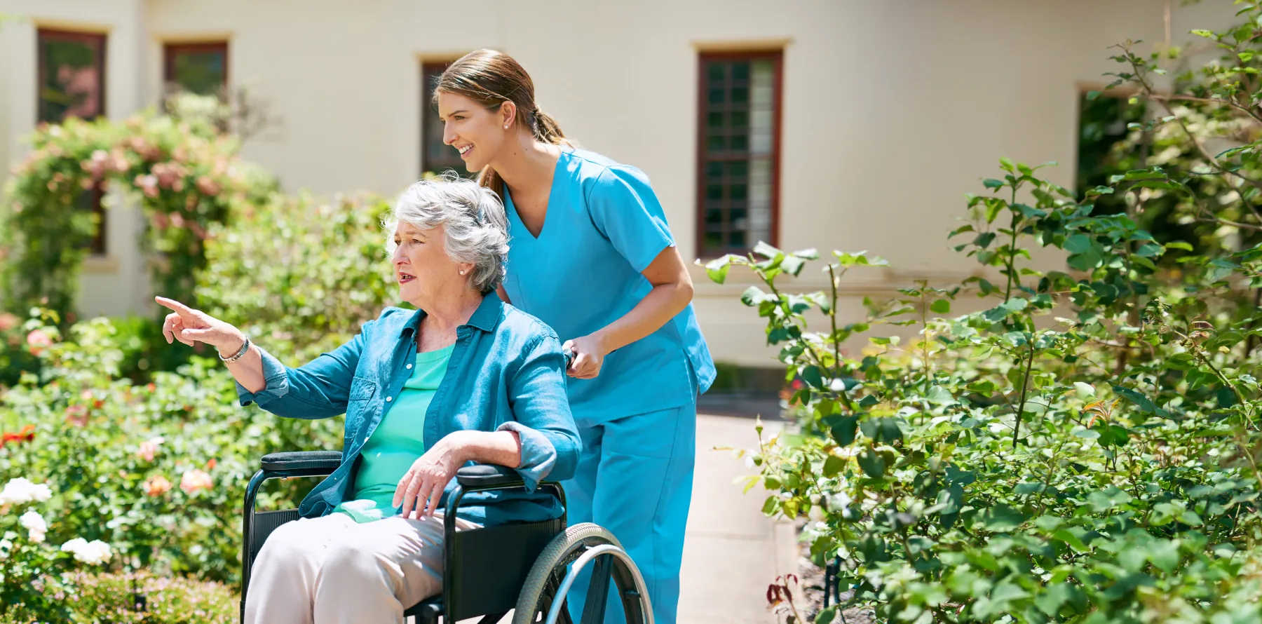 Home Health aide pushing lady in wheelchair