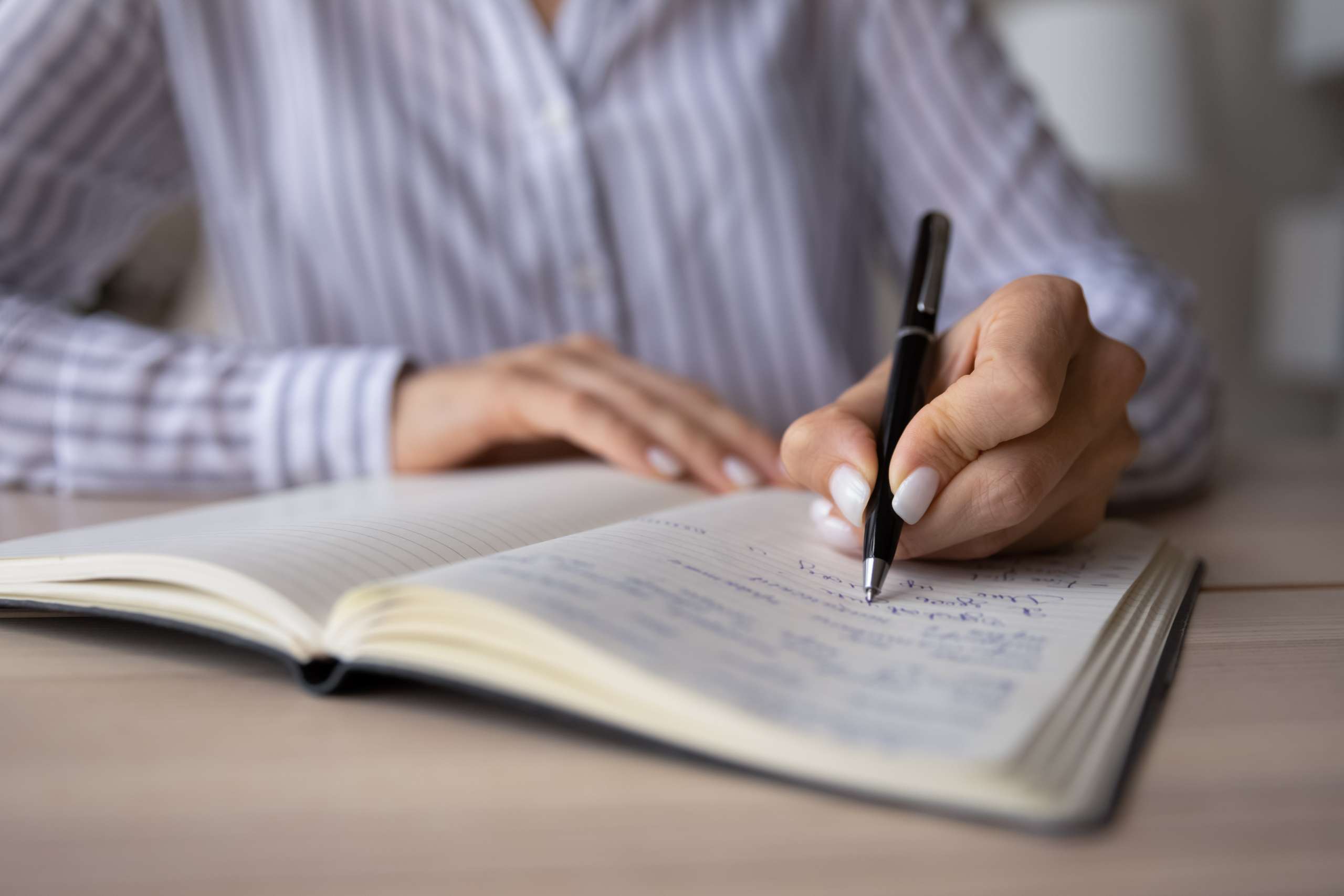 Woman makes notes in notebook