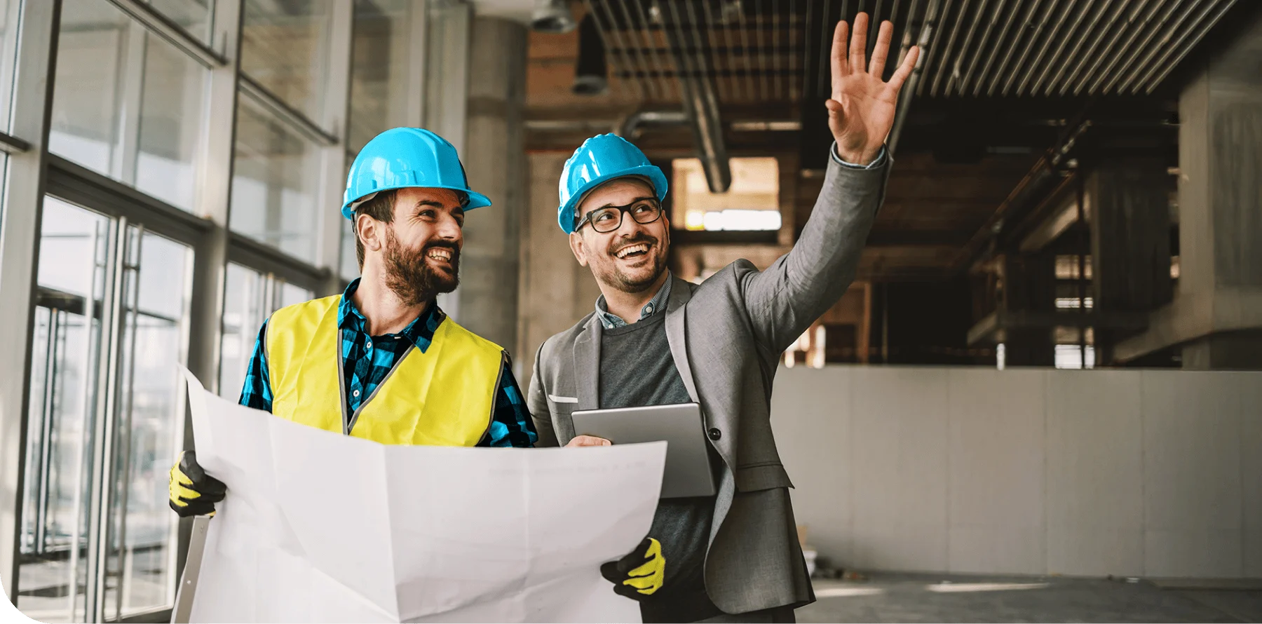General contractors at a worksite with blueprints on their hands