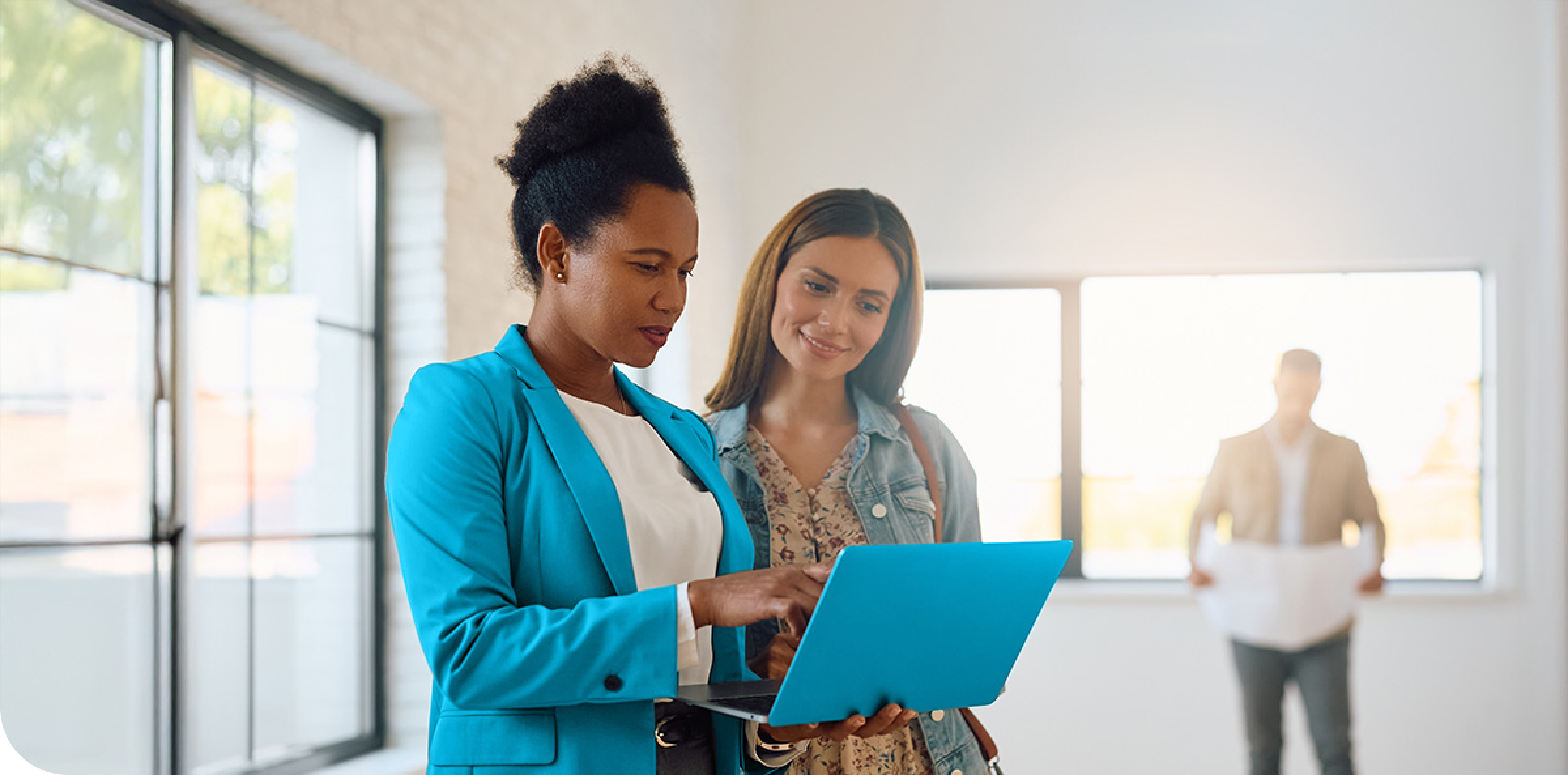 Real estate agent with a laptop showing a client